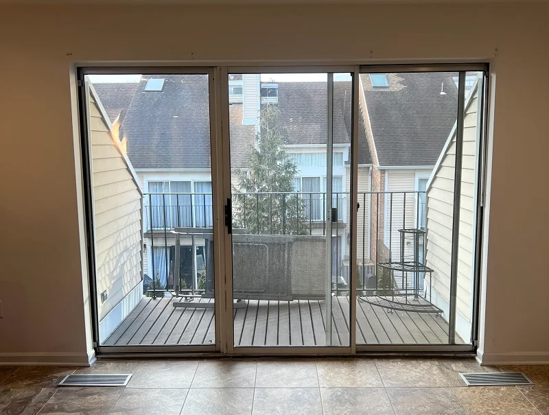 Old triple sliding patio door in a Stamford condo