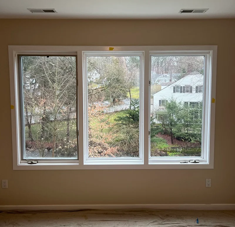 Interior view of a wood triple casement window which does not operate well