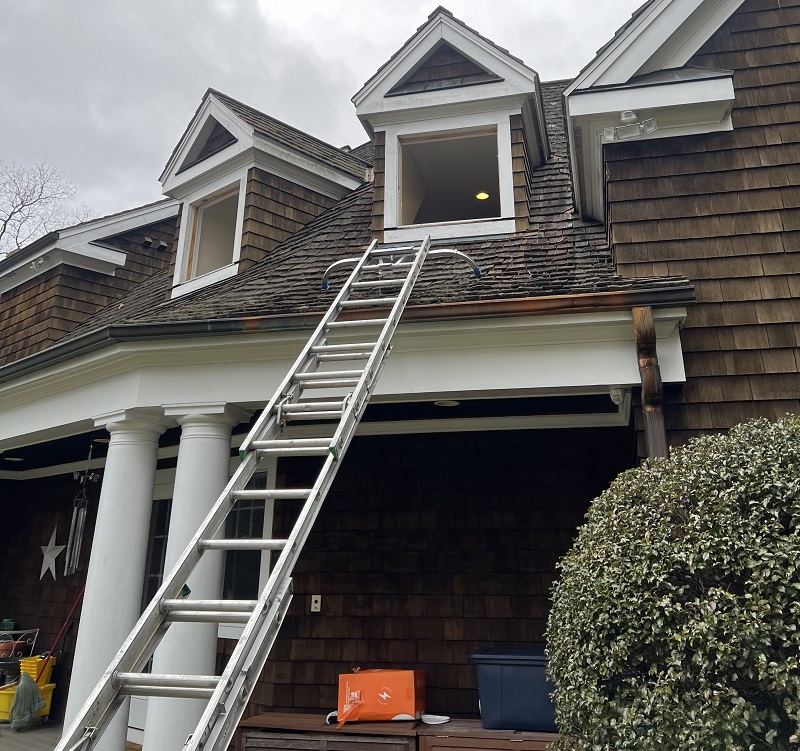 Putting a ladder on this wood roof was necessary to remove this window in Easton, CT
