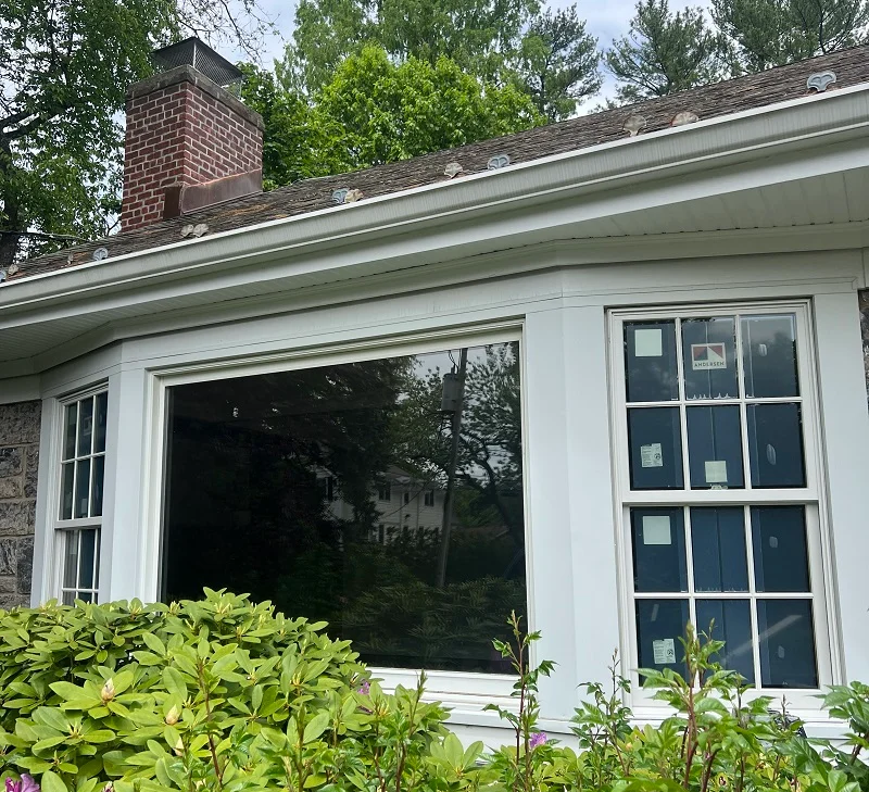 Andersen windows being installed in bay window of a Scarsdale, NY colonial home