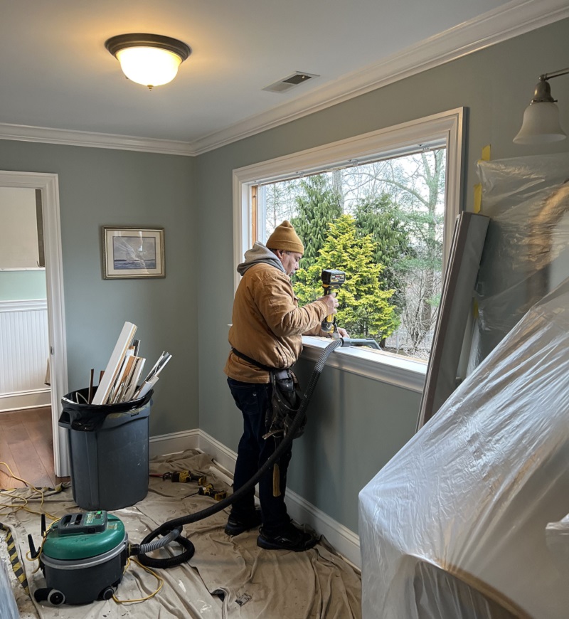 Window Solutions Plus master installer using a oscillating tool and a HEPA vac during a window installation in Easton,CT