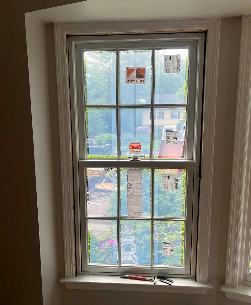 Andersen windows being installed in a Scarsdale, NY colonial home